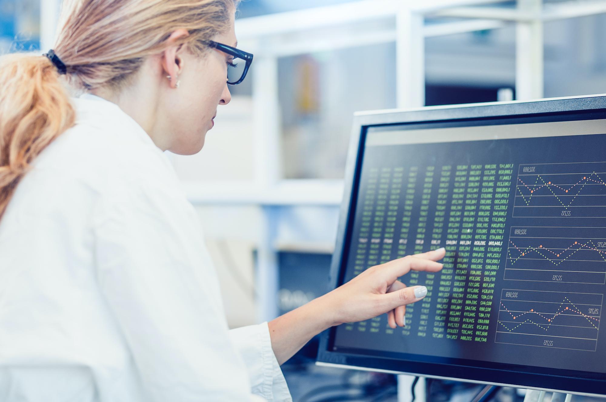 Scientist Interacting With The Computer Via Touch Screen